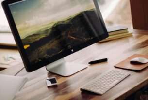 space gray iMac near Magic Keyboard on brown wooden computer desk during daytime